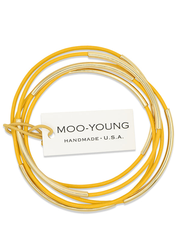 leather skinny bangles shown in a bright citrus yellow with gold plated stainless steel beads.
