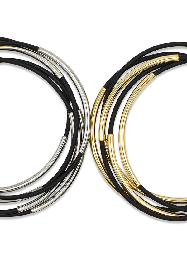 A comparison of the same matte black leather bangles with stainless steel beads and 14k gold plated beads.
