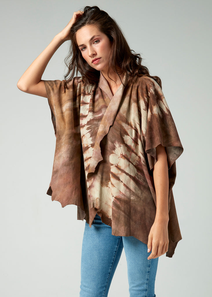 Leather poncho on model  shown with raw edges and earthy tones.